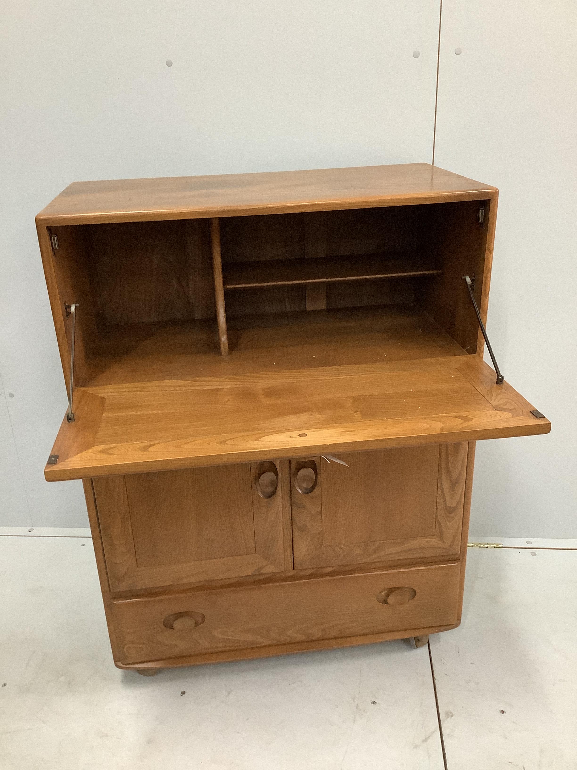 An Ercol elm bureau / cabinet, width 82cm, depth 44cm, height 109cm